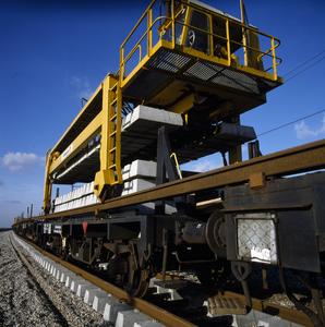 800014 Afbeelding van het leggen van betonnen dwarsliggers door Strukton.N.B. Mogelijk betreft het hier de aanleg van ...